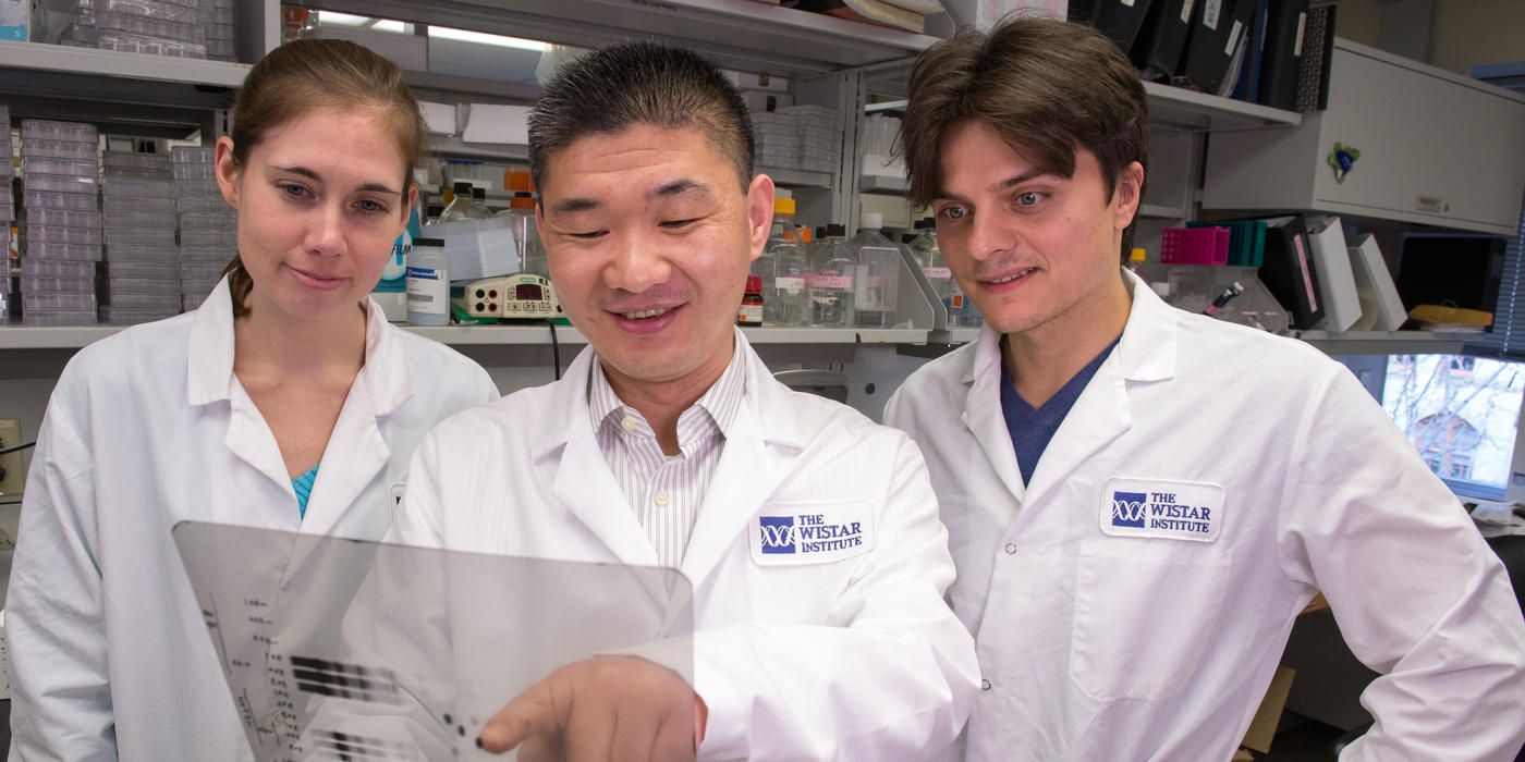Dr. Rugang Zhang with two lab members