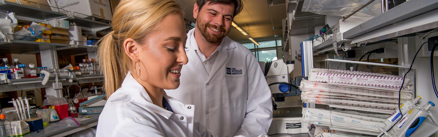 Dr. Daniel Kulp works with a fellow scientist in a Wistar lab